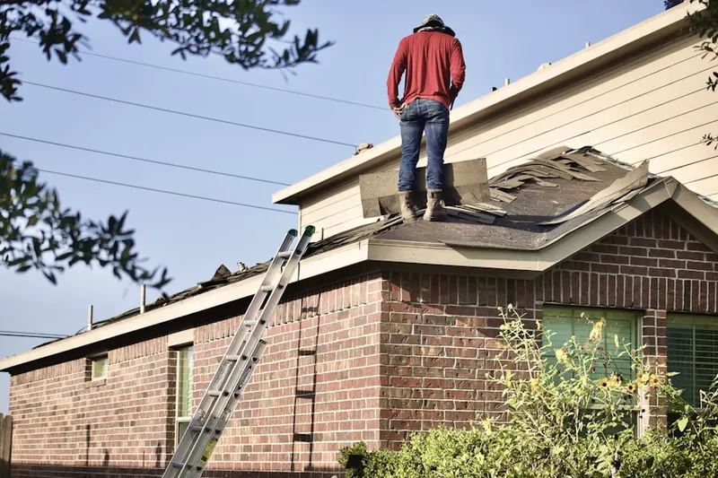Professional roofer working on a residential roof in Poland